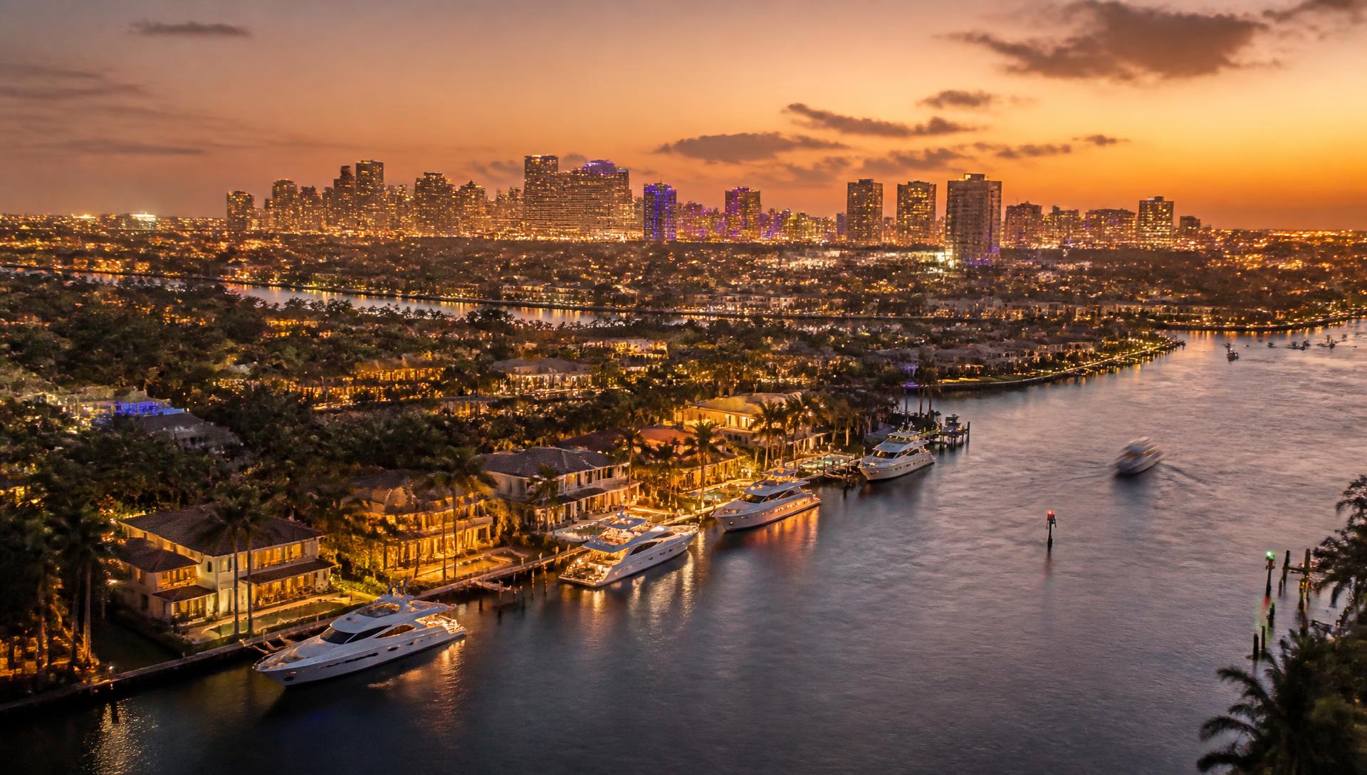 Fort Lauderdale waterfront homes and the downtown skyline at dusk